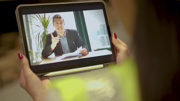 Young female worker conference video call on tablet talks with Businessman working through documents