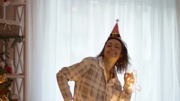 Slow Motion Portrait of Happy Cheerful Pretty Woman Wearing Pajama and Little Elf Cap Headband