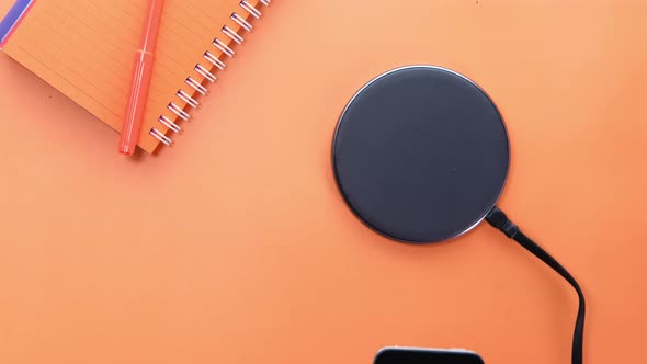 Charging Smartphone Using Wireless Charging Pad, Top View 