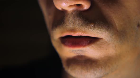 Young man vaping an electronic cigarette, vaper. Smoke generated by the cigarette. Concept of smoker