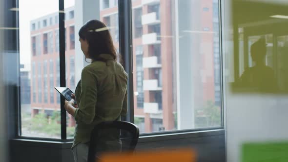 Caucasian businesswoman in meeting room using tablet