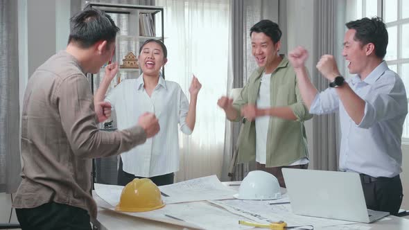 Group Of Asian Engineers Celebrating Finish Working At The Office