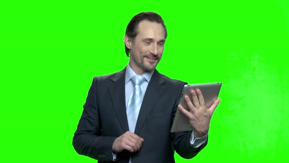 Successful Businessman with Tablet Talking