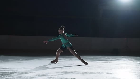 Junior Female Champion in Figure Skating is Training on Rink Performing Jump and Spin Girl is
