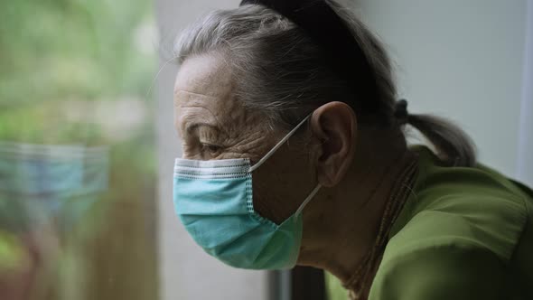 Old Woman Looks Out the Window