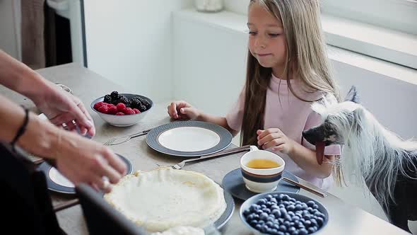 Happy Mom and Daughter Having Breakfast Together