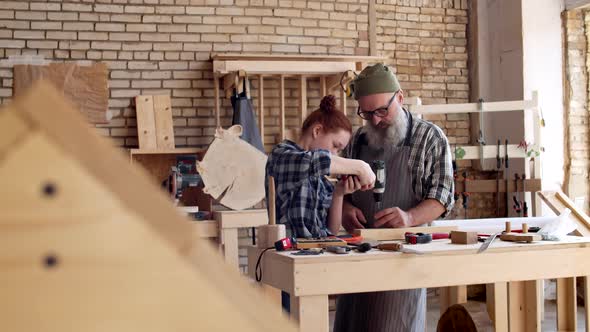 Granddad and Granddaughter Working in Joinery