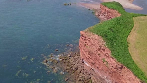STATIC CROP, Aerial, soaring high over the Jurassic Coast red cliffs in Devon