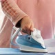 Female Hands Ironing Clothes with Iron on Ironing Board - VideoHive Item for Sale
