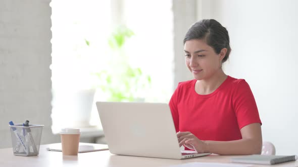 Busy Indian Woman Using Laptop in Office