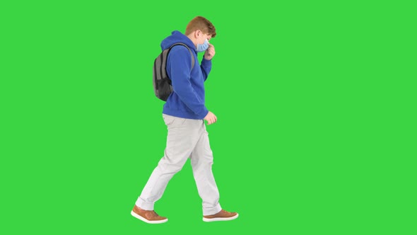 Schoolboy with Backpack Wearing Medical Mask Walking on a Green Screen Chroma Key