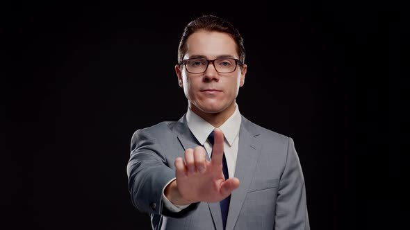 Studio portrait of successful and smart businessman in suit and tie.