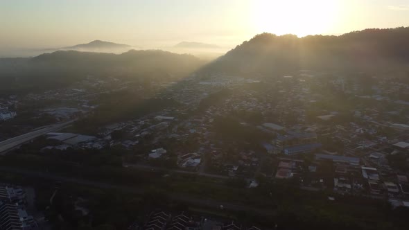 Aerial fly over small town in sunny morning