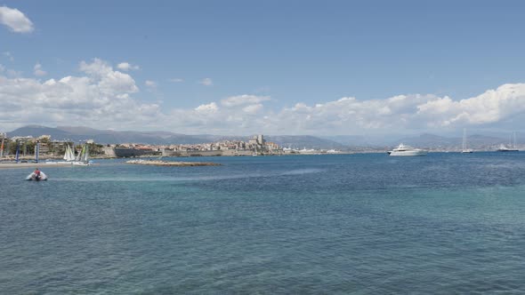 ANTIBES, FRANCE - JULY 2017  French riviera city with beautiful  blue sea and Alps in background