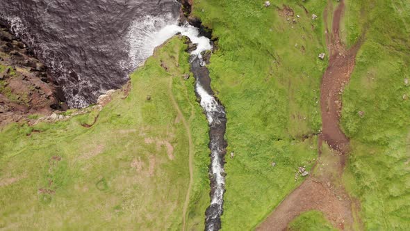 Stunning Waterfall Splashing From Cliff Aerial View. Mulafossur Waterfall Near Gasadalur Village at