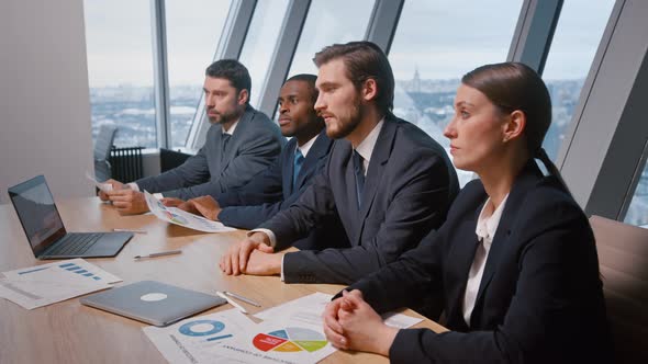 Young corporate leader with his team at a meeting with partners