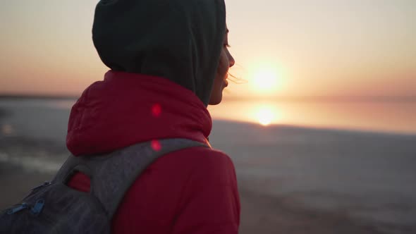 Close Up Portrait of Beautiful Woman Hiker in Hoodie Enjoying Amazing Sunrise Over Mineral Salt Lake