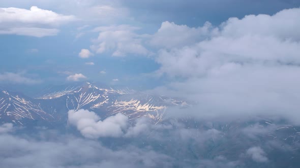 Flying Above Clouds and Snowy Mountains