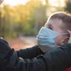Woman Put Medical Mask on Face of Little Cute Boy and Hugs Him - VideoHive Item for Sale