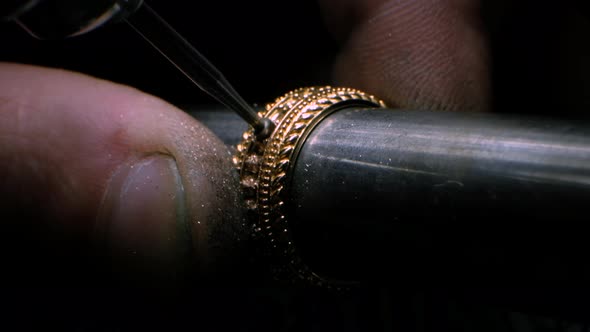 Goldsmith Using a Drill Tool to Make a Hole in Golden Ring