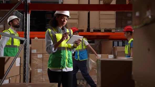 Female Supervisor Using Tablet During Stocktaking