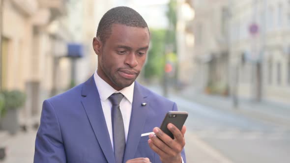 Outdoor African Businessman Using Smartphone