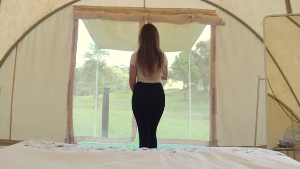 Travel Camping Woman Walks to Outside of Tent to View on Nature and Wild Animals