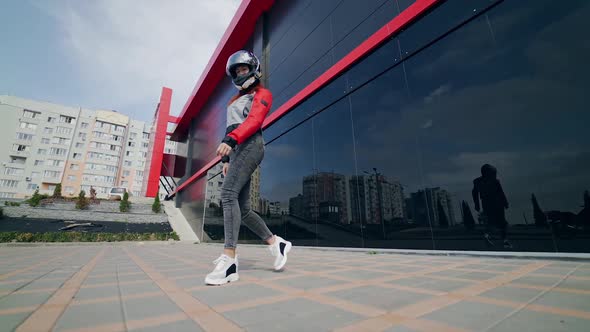 Extreme woman on motorbike. Beautiful young woman motorcyclist sitting on motorcycle with helmet