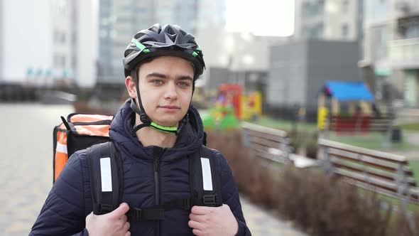 Delivery Courier Walking Along Street with Order