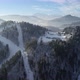 Aerial view of winter mountain resort and skiers skiing down the ski slope. Epic winter scenery - VideoHive Item for Sale