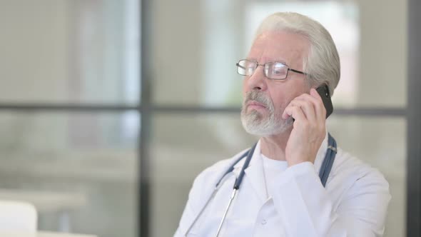Senior Old Doctor Talking on Phone