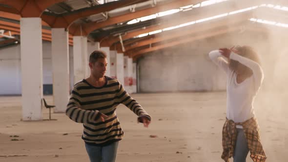 Dancers in an empty warehouse