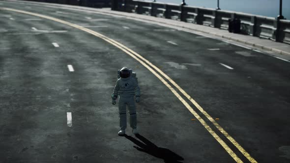 Astronaut Walks in the Middle of a Road