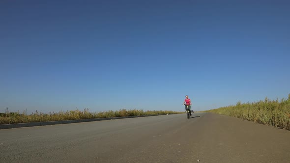 Cyclist Rides a Yellow Bike, Pedals