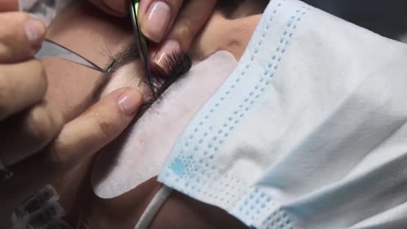 in a Beauty Salon a Woman Undergoes an Eyelash Extension Procedure