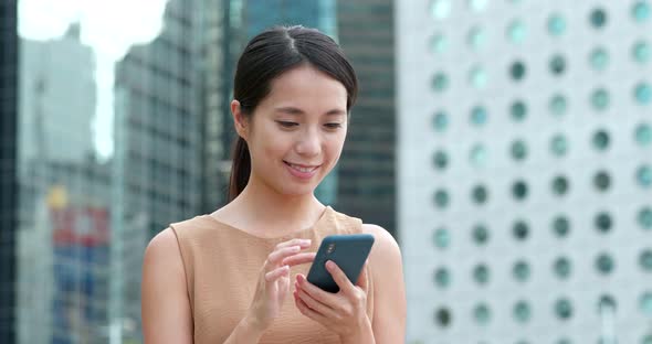 Woman use of mobile phone in city of Hong Kong