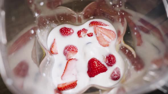 Housewife Throws Fresh Berries Into Milk in Bowl to Mix