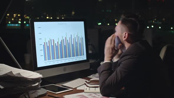 Tired Businessman Analyzing Financial Data