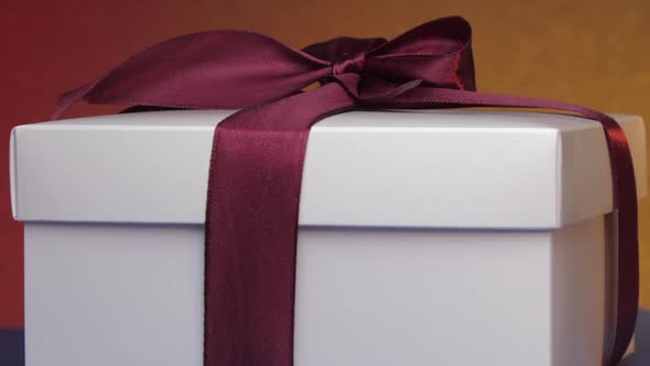 White Present Carton Box with Purple Ribbon and Bow