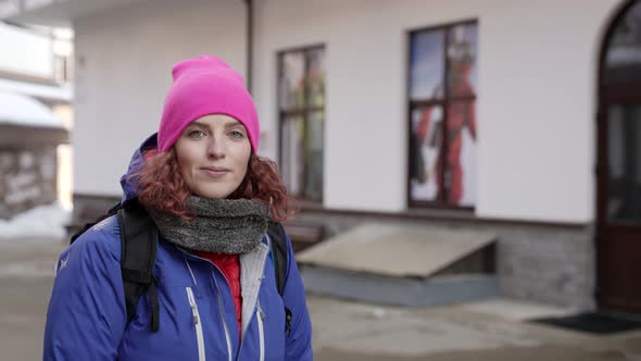 A Woman in a Pink Hat and a Blue Jacket