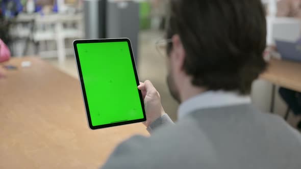 Man Using Tablet with Green Screen