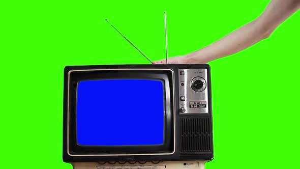 Retro TV Set turning on Blue Screen over Green Background.