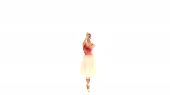 Attractive Ballerina Making Dance Trick, Grands Battements, on White Background
