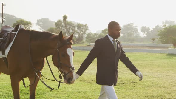 African American man walking with his dressage horse