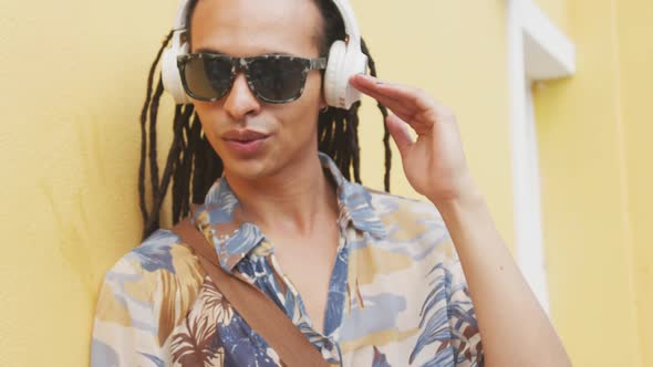 Mixed race man listening to music with headphone
