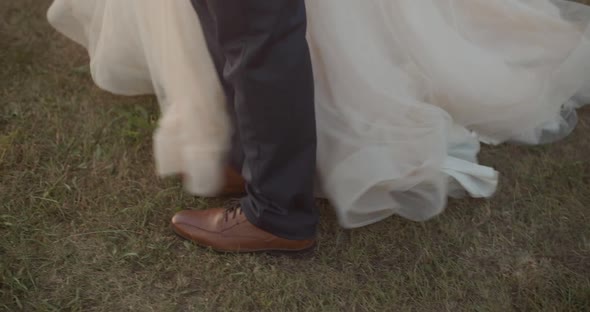 Female and male feet. The legs of the bride and groom walk in the park