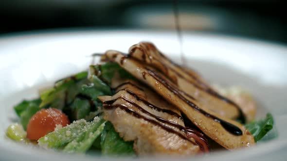 Juicy Caesar salad poured over balsamic vinegar