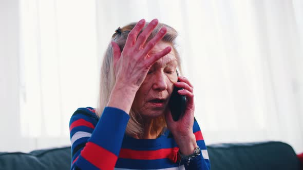 Desperate Worried Elderly Woman Having a Phone Call