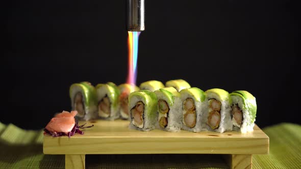 Sushi in Black Background Being Flame Torched