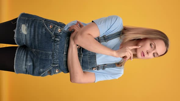 VERTICAL VIDEO POV Pensive Woman in Overalls Thinking Brainstorming Solving Problem Posing Isolated